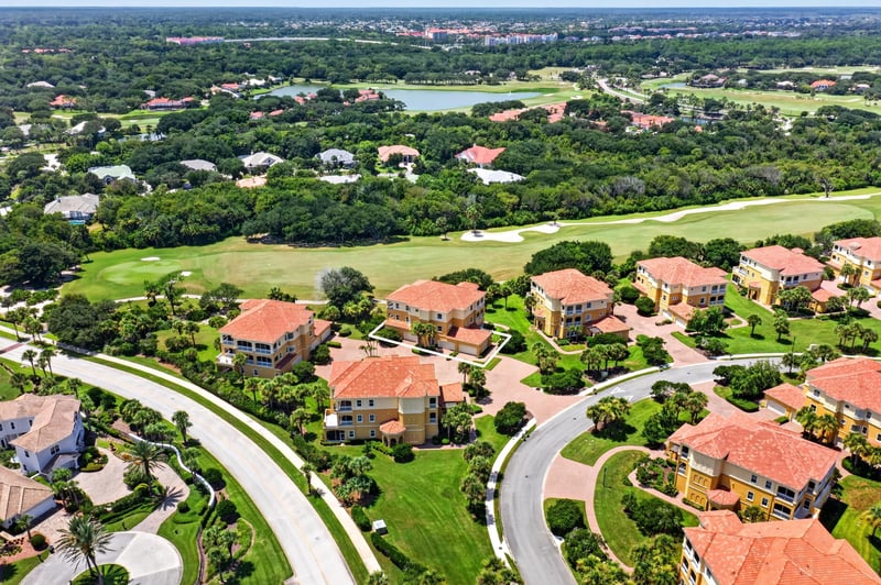 Aerial of golf course and tree-lined community streets in Palm Coast, FL