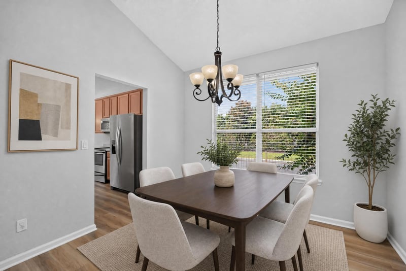 Dining nook virtually staged with table and chandelier at 3101 E Banister Rd, St. Augustine, FL 32092