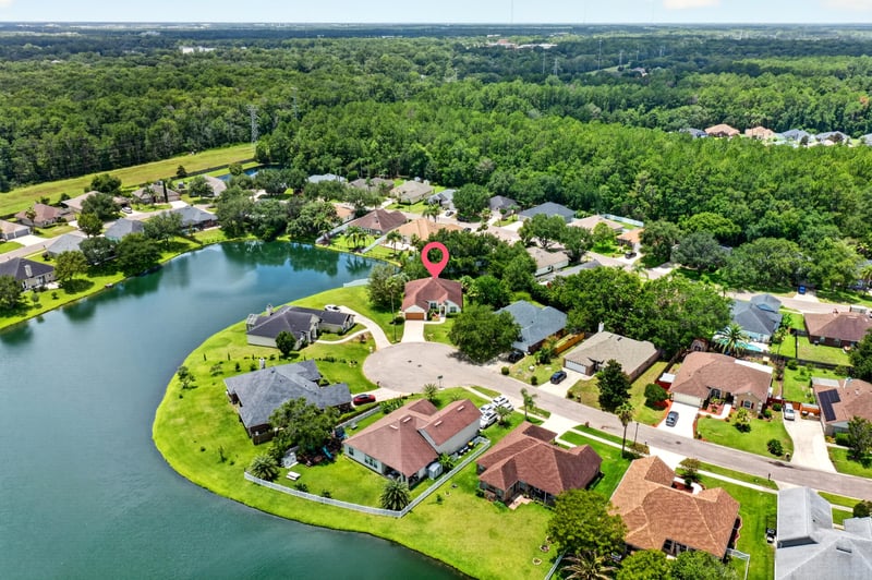 Aerial view of a lake and surrounding rooftops in Windsor Chase