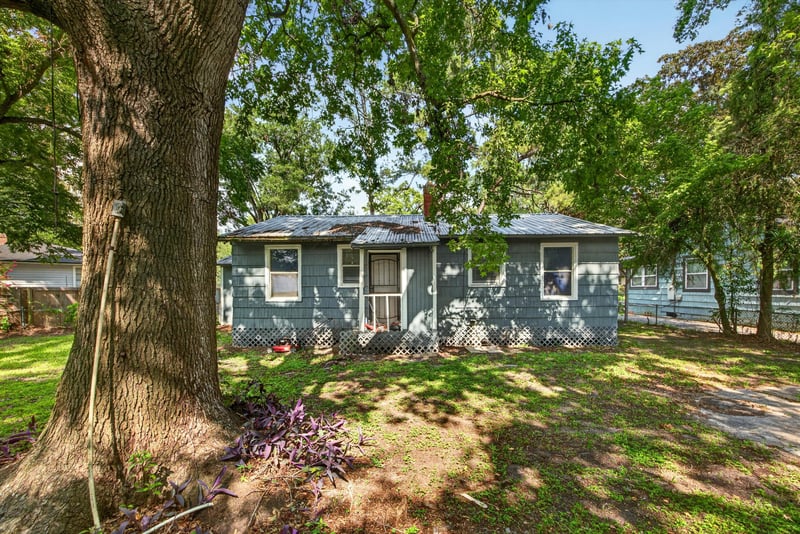 Exterior view with large tree and lawn at 2132 Allandale Cir W, Jacksonville, FL