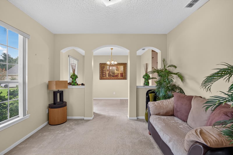 Formal living room with archway and columns at 2875 Pebblewood Ln, Orange Park, FL 32065