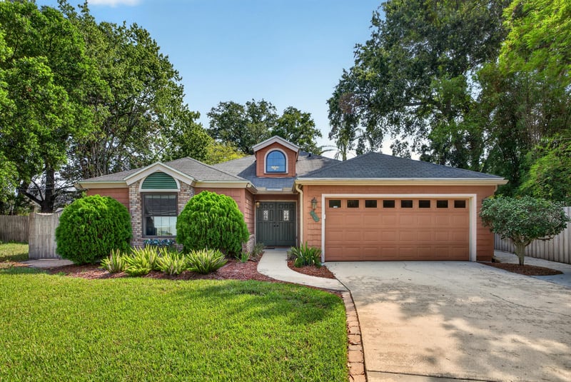 Front exterior with landscaped lawn at 4837 Pareja Ct, Jacksonville, FL 32225