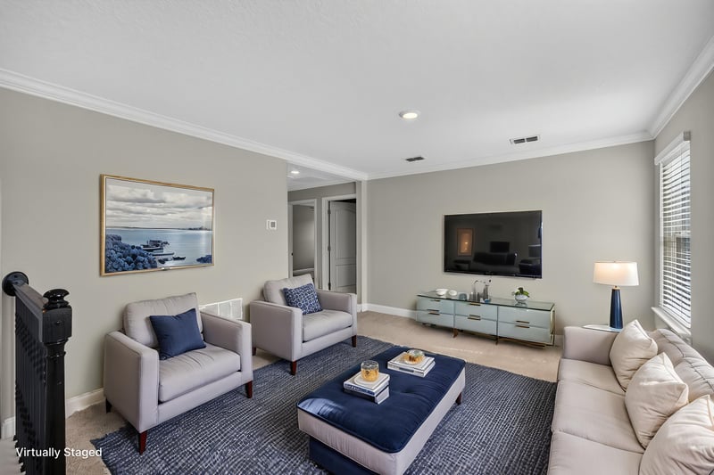 Living room with sofa and TV, virtually staged, at 331 Millerstone Dr, St. Augustine, FL 32092