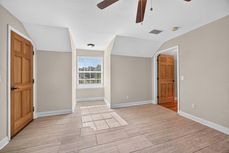 Bedroom with tile floor and closet doors at 1735 Hagans Ridge Ct