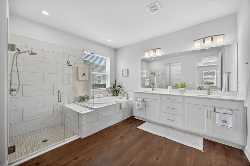 Primary bathroom with soaking tub and dual vanity at 85491 Fall River Pkwy, Fernandina Beach, FL 32034