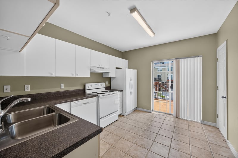 Kitchen with white cabinets, sink and sliding door at 342 E Ashley St, Jacksonville, FL 32202