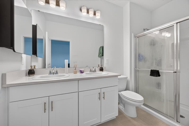 Primary bathroom with double vanity and glass shower at 339 Anthony Dr, Jacksonville, FL