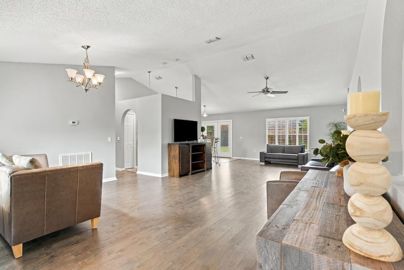 Great room with ceiling fan open to kitchen at 11197 Illford Dr
