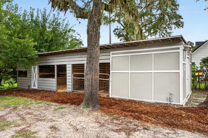 Shed exterior with oak tree at 1161 Whispering Pines Rd, Jacksonville, FL 32259