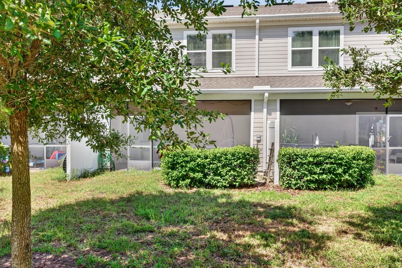 Backyard view with screened porch at 1186 Beach Dune Dr, Jacksonville, FL 32233