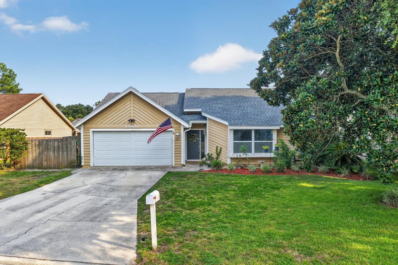 Front exterior with two-car garage and driveway at 13020 Medford Ln, Jacksonville, FL 32225