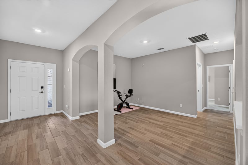 Entry flex room with wood-look flooring at 9942 Lovage Ln, Jacksonville, FL 32219