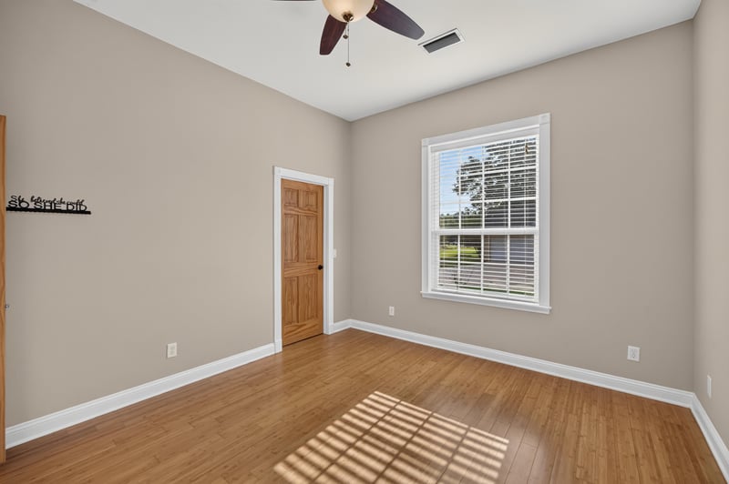 Bedroom with hardwood floors and closet door at 1735 Hagans Ridge Ct