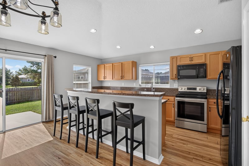 Kitchen with sliding glass door to backyard at 7545 Lirope St, Jacksonville, FL 32244
