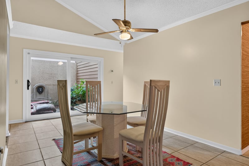 Dining area with glass table and sliding doors to patio at 3515 Cormorant Branch Ct, Jacksonville, FL