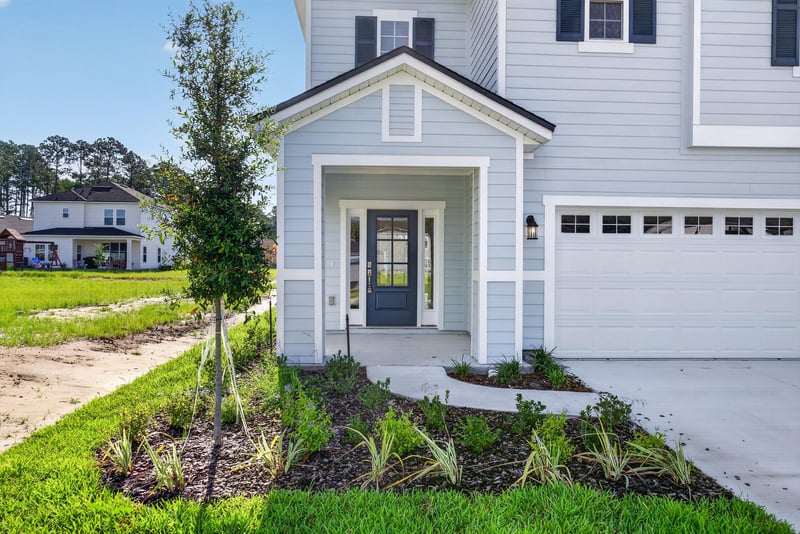 Close-up front exterior with covered porch and landscaping at 269 Bluegrass Wy, St. Augustine, FL 32092