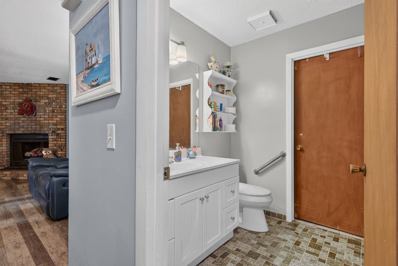 Bathroom hallway with fireplace view and doors at 3249 Maryland Ave, Green Cove Springs, FL