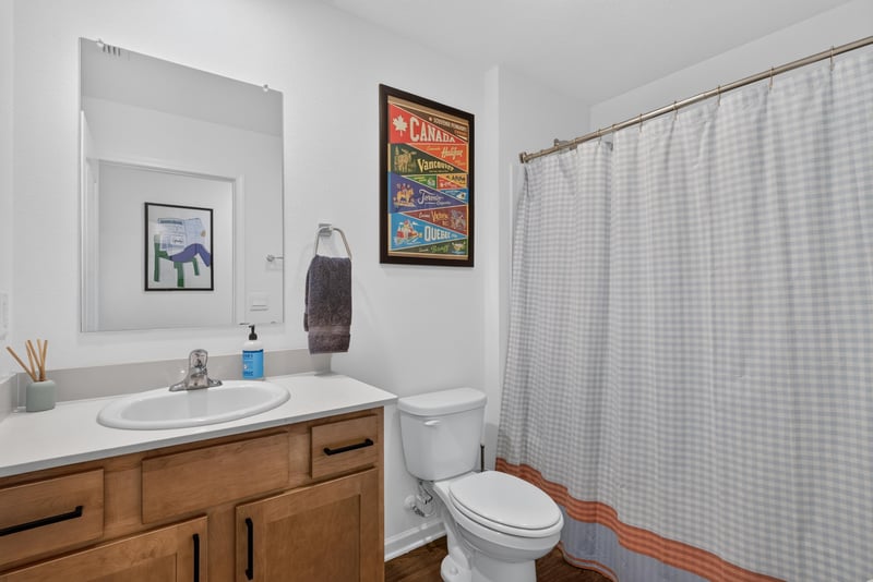 Bathroom with wood vanity and tub at 4276 Quaking St, Jacksonville, FL 32218