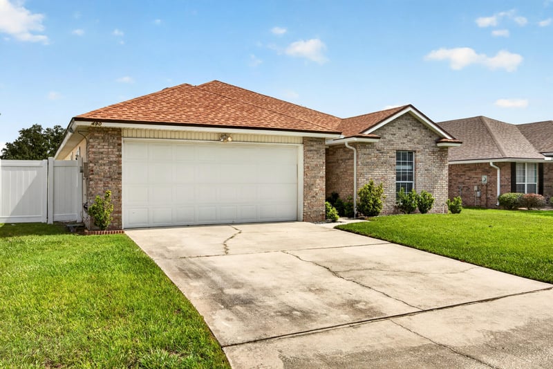 Front exterior view across driveway and lawn at 490 Hillside Dr, Orange Park, FL 32073