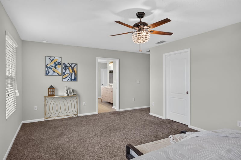 Primary bedroom with closet doors and carpet at 6830 Hanford St, Jacksonville, FL 32219