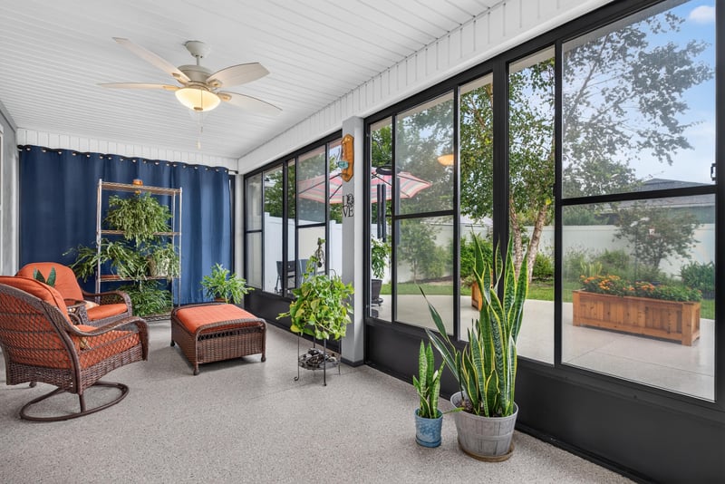 Screened lanai with ceiling fan and plants at 4319 Green River Pl, Middleburg, FL 32068
