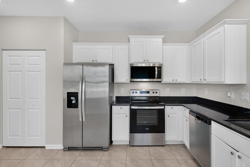 Kitchen island with sink and stainless appliances at 4024 Bay Hawk Ct, Jacksonville, FL