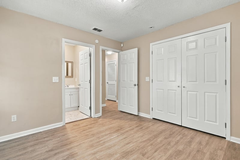 Hallway with closet doors and bathroom entry at 219 Shortreed St, Jacksonville, FL 32254