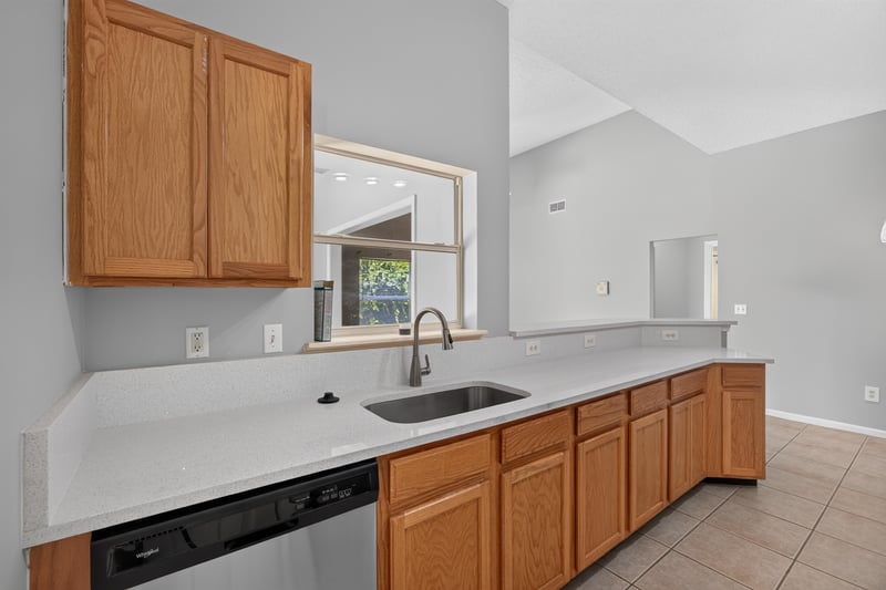 Kitchen with wood cabinets and window over sink at 9256 Dale View Ln W, Jacksonville, FL 32225
