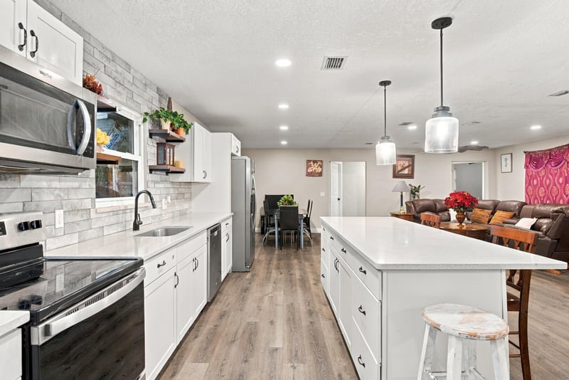 Kitchen sink and stove with tile backsplash at 357 Dillon Dr, Orange Park, FL