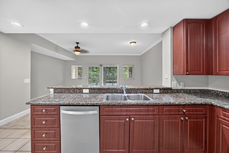 Kitchen sink and dishwasher with granite counter at 9745 Touchton Rd, Jacksonville, FL 32246