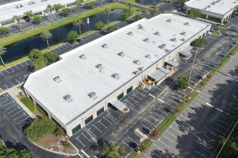 Aerial view of a roofline with pond, fountain and palm trees at 10550 Deerwood Park Blvd, Jacksonville, FL 32256