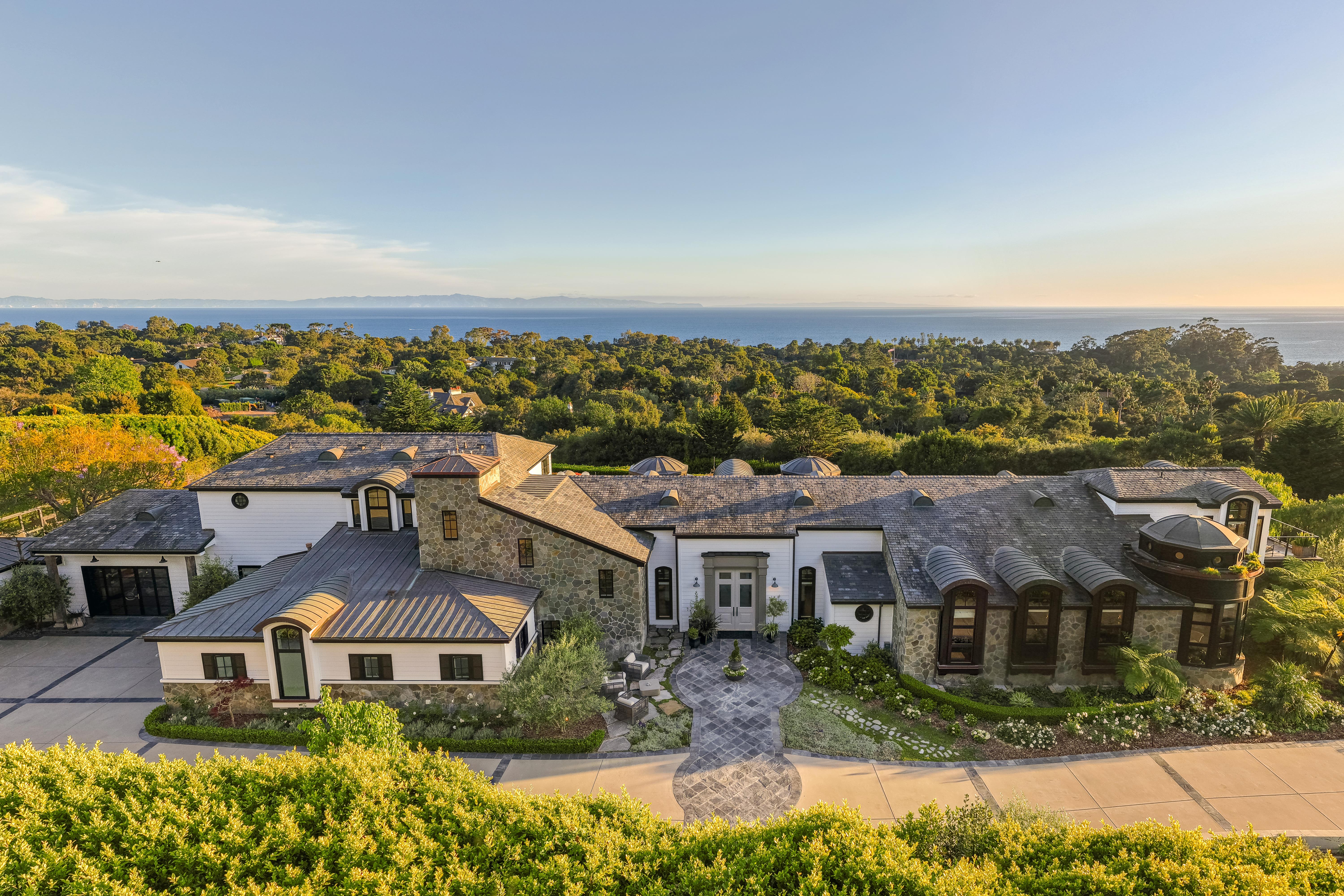 Professional real estate photography of the illuminated front elevation at 4265 Cresta Ave, Santa Barbara, with the Santa Ynez Mountains fading into dusk — virtual tour photography by VirTour Media. Our team captured twilight video and daytime and twilight reels from evening through twilight.