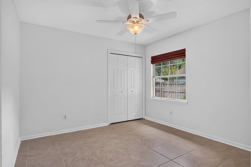 Bedroom with closet and window at 12810 Swamp Owl Ln