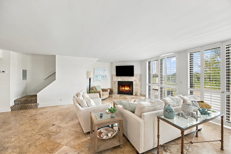 Living room with fireplace and tall windows at 752 Spinnakers Reach Dr, Ponte Vedra Beach, FL 32082