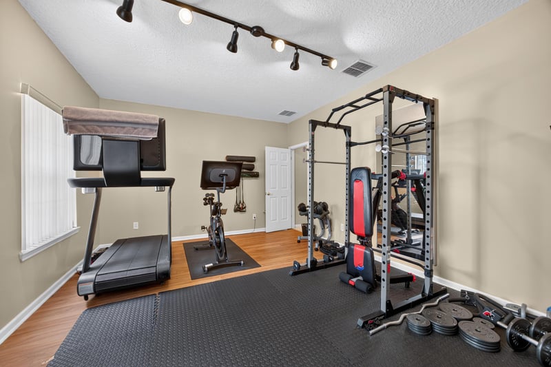 Home gym with treadmill and weight rack at 2875 Pebblewood Ln, Orange Park, FL 32065