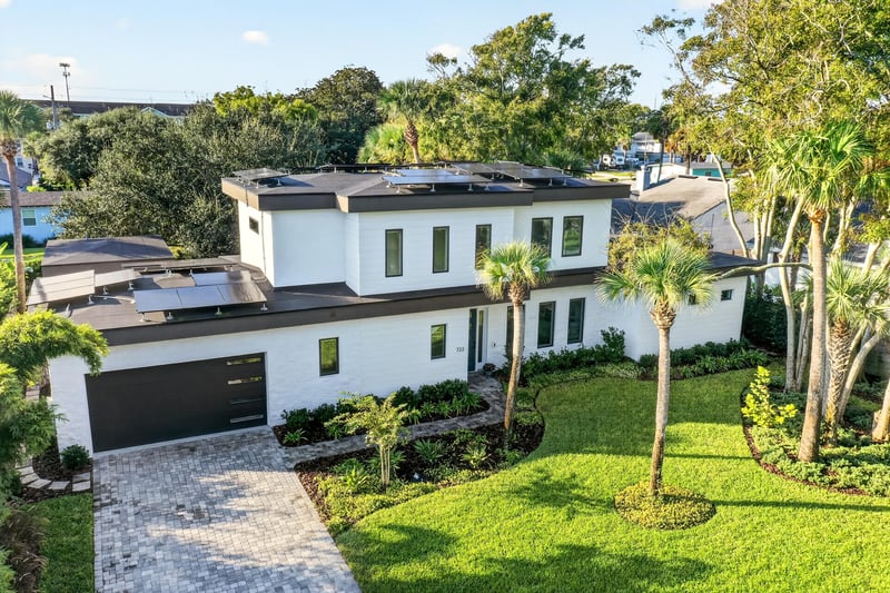 Aerial view of the home's roofline, driveway and yard at 722 3rd Ave N, Jacksonville Beach, FL