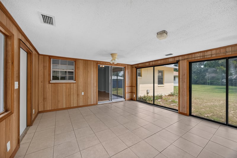 Sunroom with tile floor, ceiling fan, and sliding glass doors at 328 Palos Ct, St. Augustine, FL
