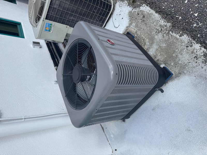 Gray AC condenser unit with fan grille at 11700 New Kings Rd, Jacksonville, FL 32219