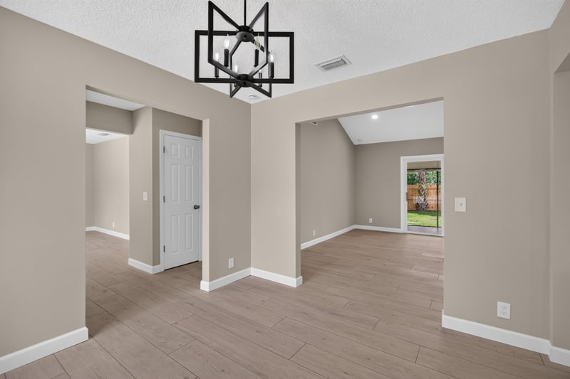Empty open living area with pendant light fixture at 4117 Wilcrest Ct, Jacksonville, FL 32277