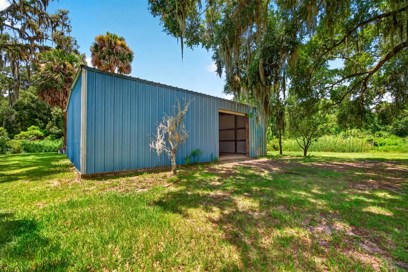 Blue metal barn viewed from the side at 1173 US-17, Satsuma, FL 32189