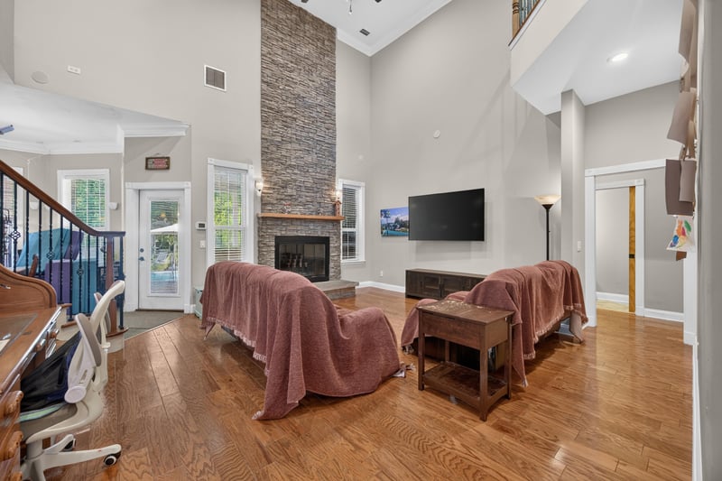 Great room with covered furniture and stone fireplace at 1735 Hagans Ridge Ct