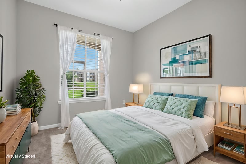 Bedroom with staged bed and artwork at 7990 Baymeadows Rd E #404, Jacksonville, FL 32256