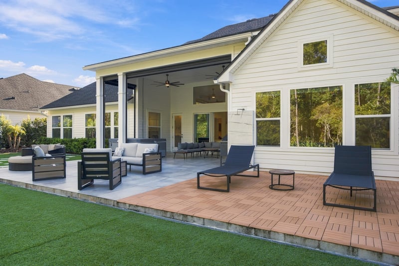 Covered patio with outdoor dining and lounge chairs at 907 Seagrove Dr, Ponte Vedra Beach, FL 32081