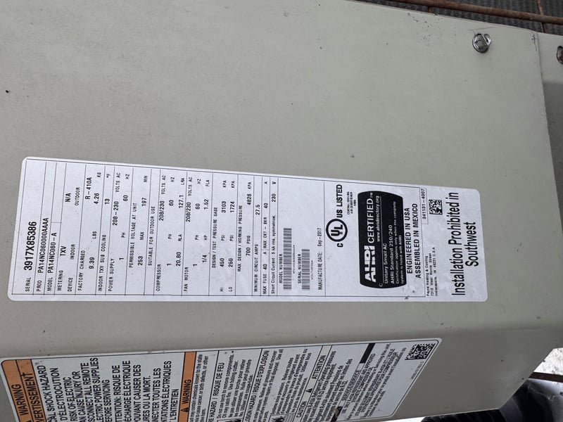 Condenser unit nameplate with installer sticker at 11700 New Kings Rd, Jacksonville, FL 32219