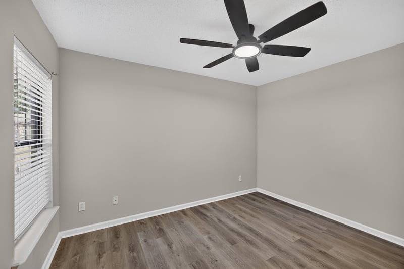 Empty bedroom with window and ceiling fan at 7723 Playschool Ln, Jacksonville, FL