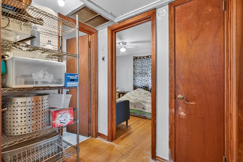 Hallway with storage shelving and bedroom doors at 450 E 46th St, Jacksonville, FL 32208