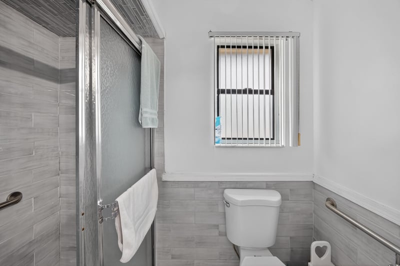 Bathroom with tiled shower and window at 981 Marble Ridge Dr, Orange Park, FL 32065