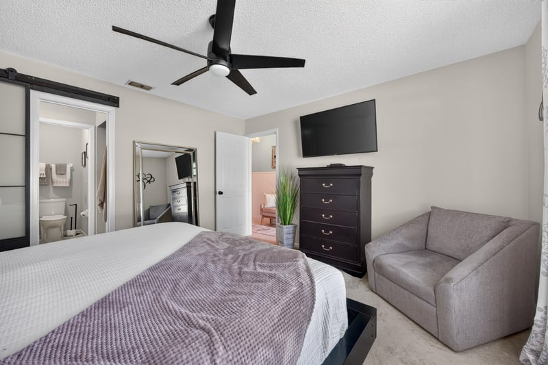 Bedroom with television and dresser at 3067 Wavering Ln, Middleburg, FL 32068