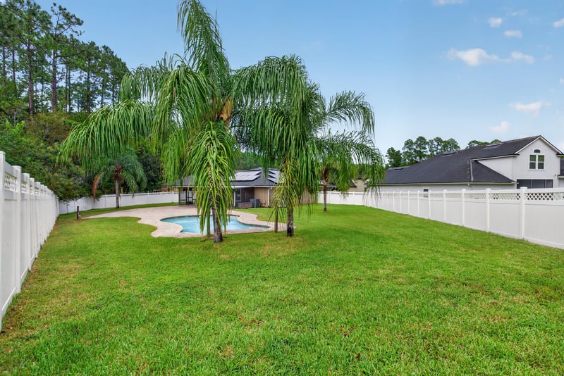 Backyard pool with palm trees at 706 Grampian Highlands Dr, St. Johns, FL 32259