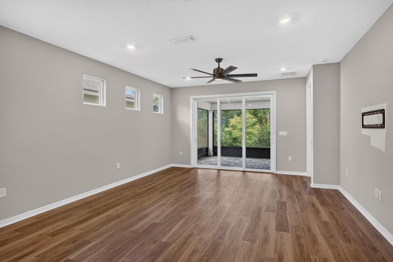Living room with ceiling fan and sliding glass doors at 171 Oyster Shell Ter, Nocatee, FL 32081